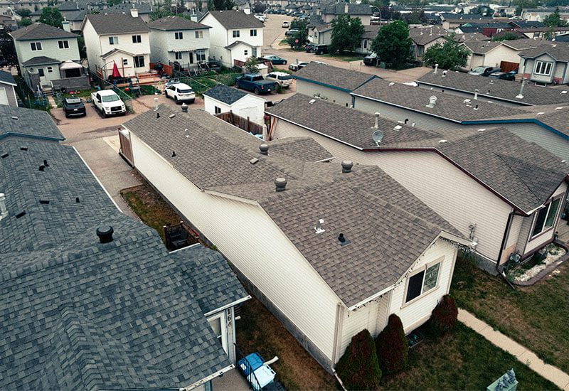 Gallery-2 Aerial view of residential homes with well-maintained rooftops.