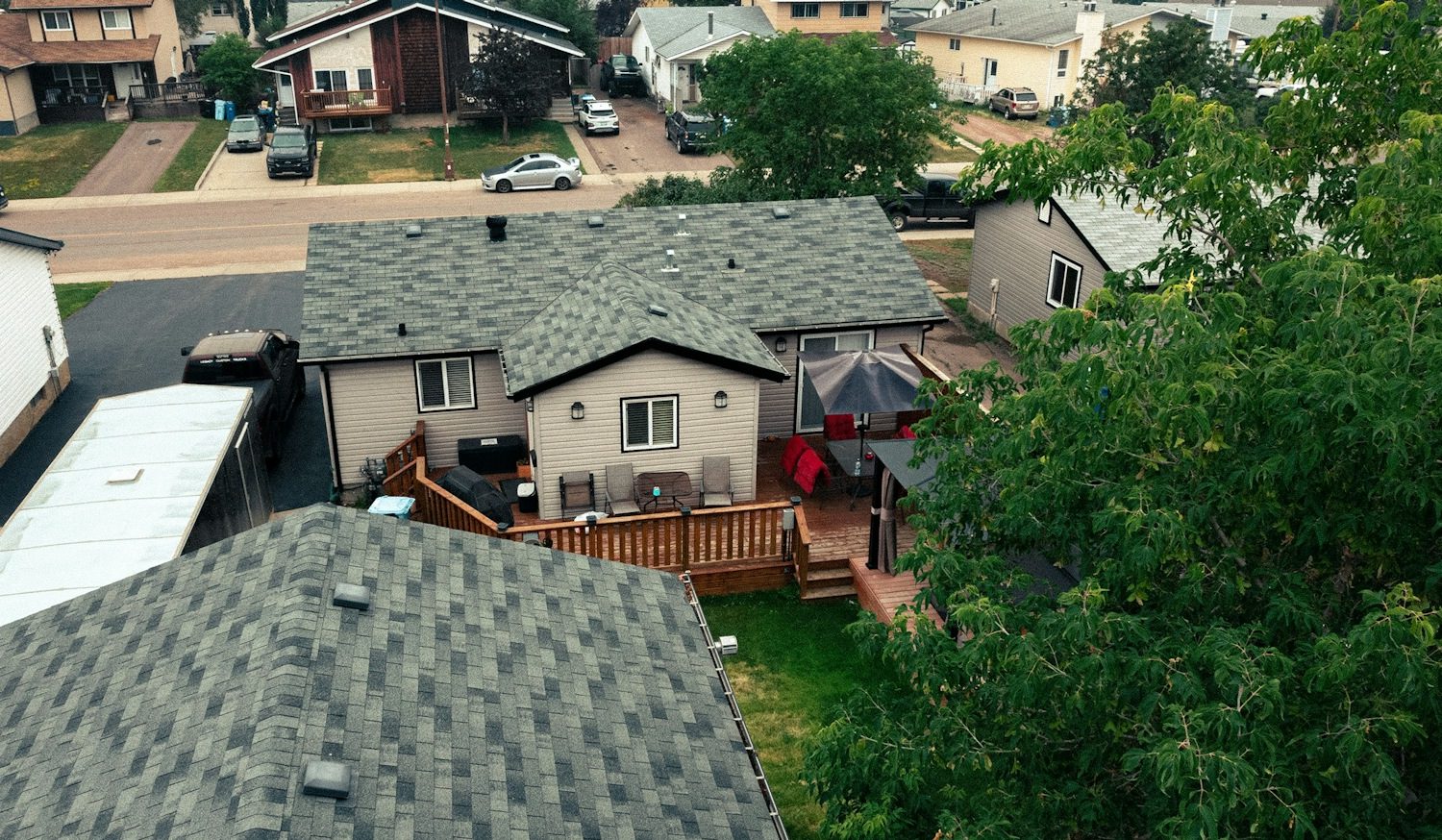 Siding 1 Residential homes with well-maintained roofs and backyard patios.